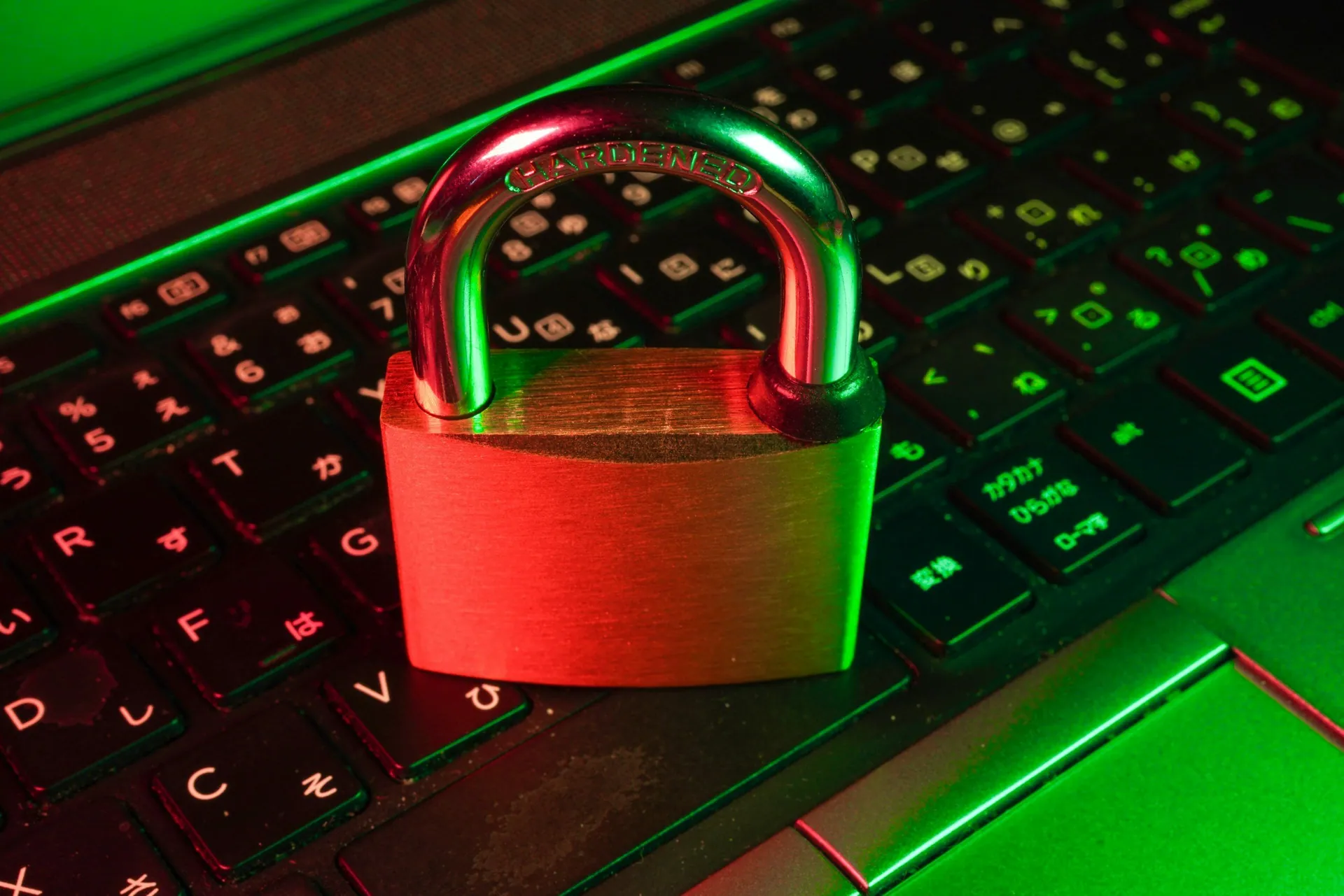 A digital keyboard with a green and red glow, featuring a metallic padlock placed on top. The padlock is labeled "GARDENED" on the shackle.