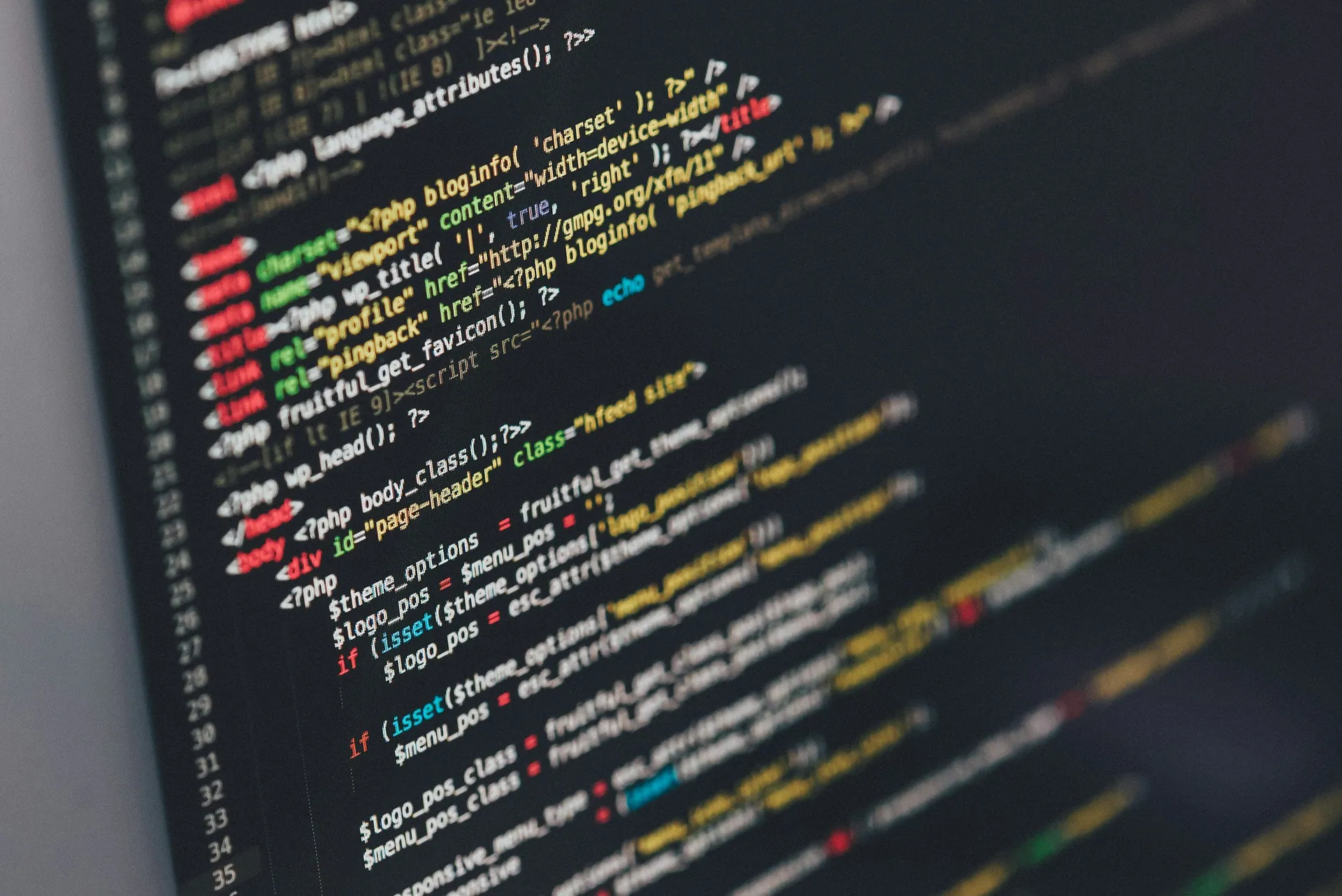Close-up of a computer screen displaying colored PHP and HTML code on a dark background.